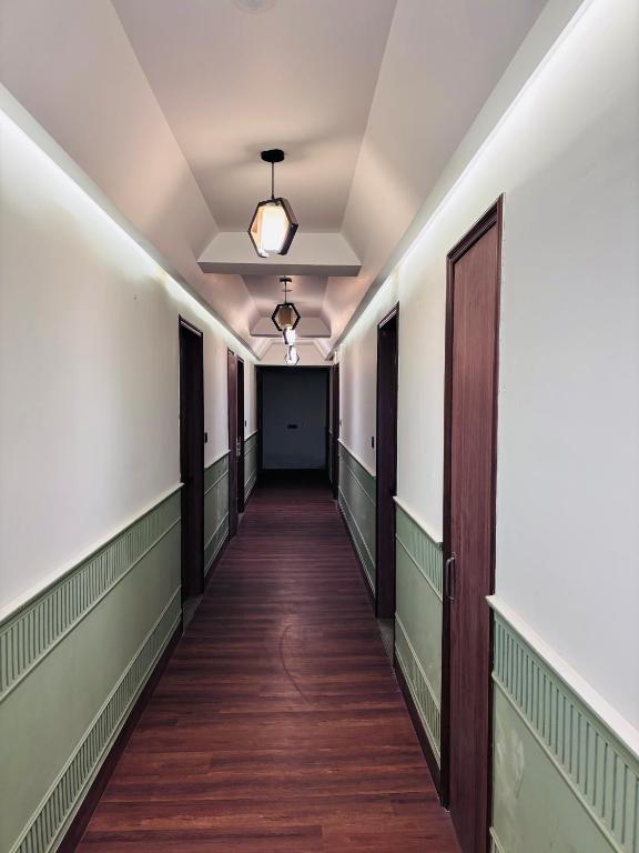 a corridor in an empty building with a hallway at Classic Hotel in Pānīpat