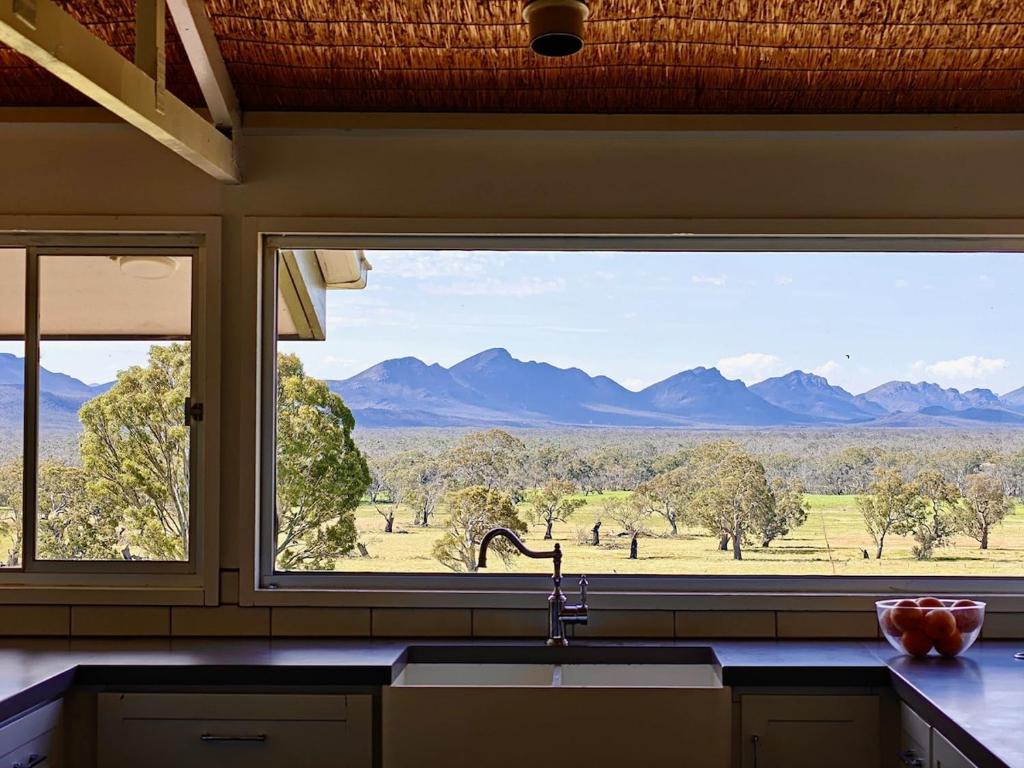 a kitchen window with a view of the mountains at Bunnugal House in Dunkeld