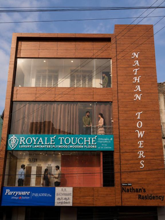 a building with a sign on the side of it at Nathan's Residency in Tiruchirappalli