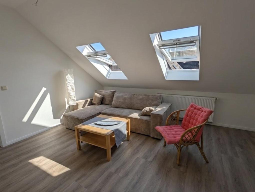 a living room with a couch and two windows at NEU - Nette kleine Unterkunft in Heide - Mit Gutscheinen für Bistro und Minigolf in Heide