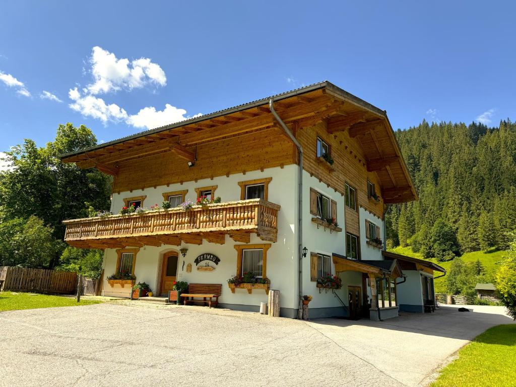 a building with a balcony on the side of it at Winklhütte in Forstau