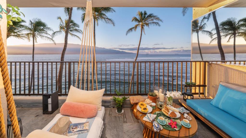 a living room with a view of the ocean at Spectacular luxury , modern oceanfront condo Maalaea-Kihei ,Maui in Wailuku