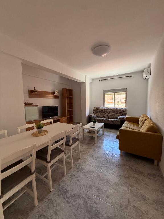 a living room with a table and a couch at Zapillo 2&1 in Almería