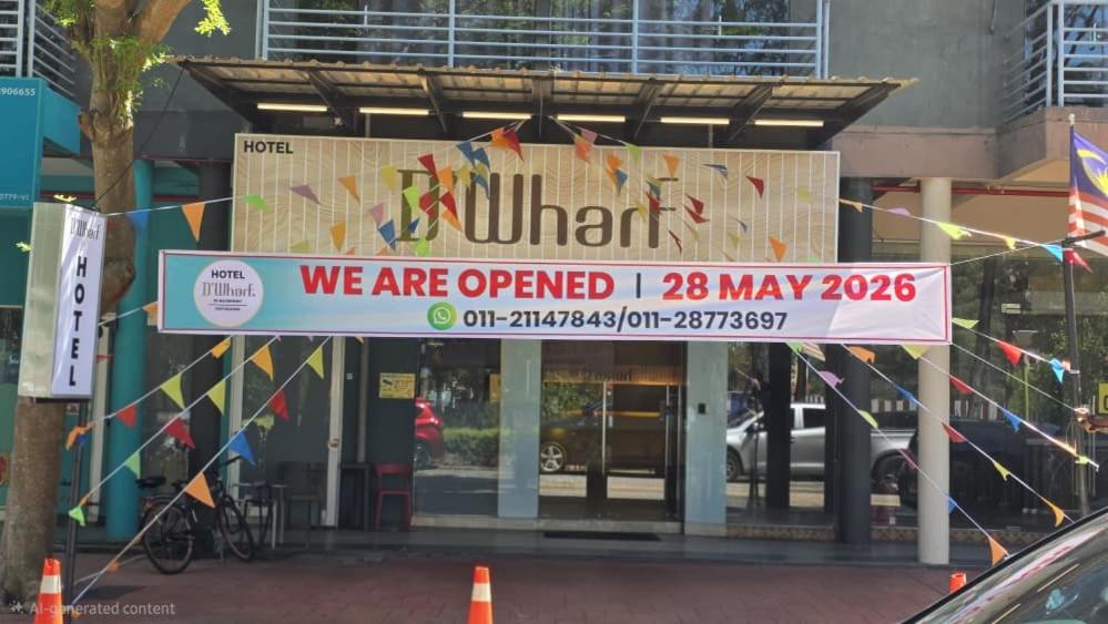 a sign in front of a building with flags at D'Wharf Hotel PD Waterfront in Kampong Bangsal Kapor