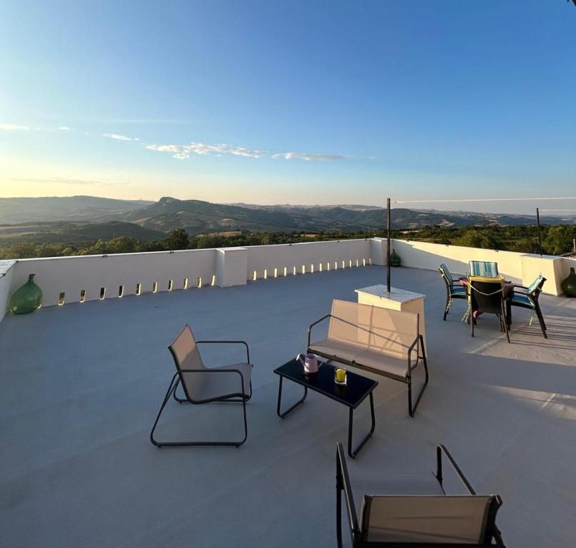 a patio with chairs and tables on a roof at Respiro di luna in Pescopagano