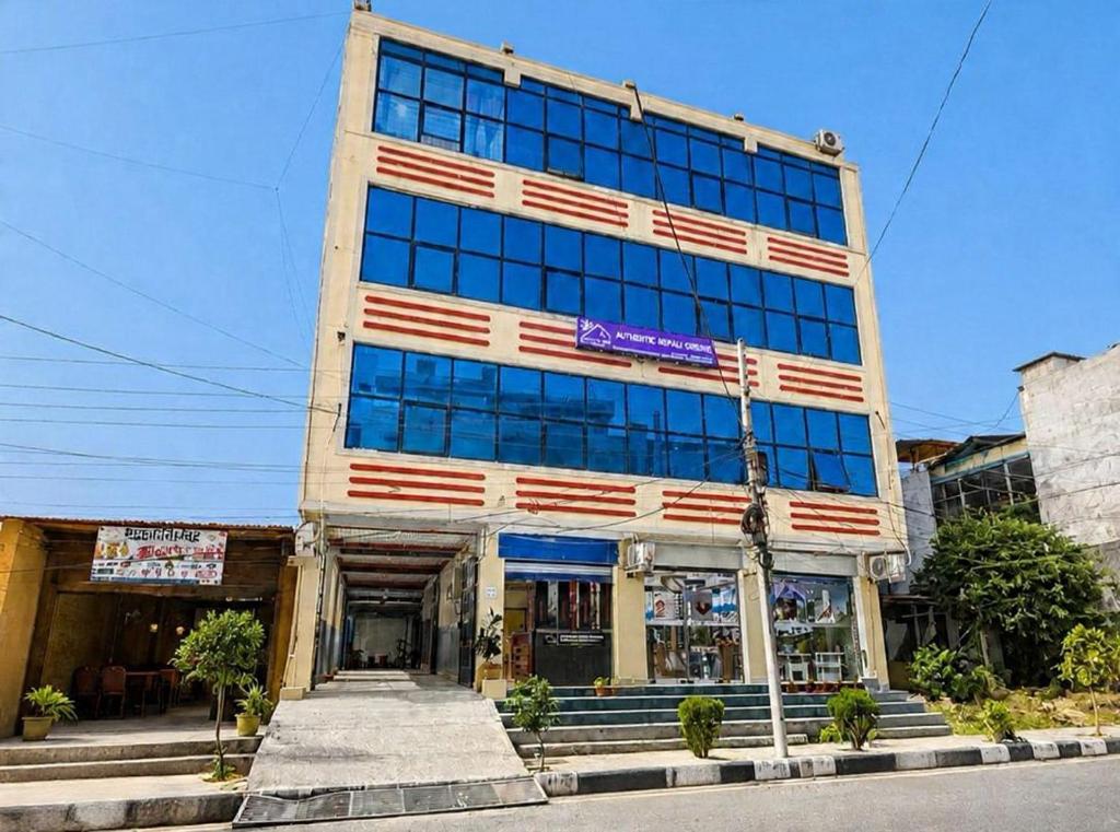 a tall building with american flags on it at Brichyalaya Kohalpur in Kohalpur