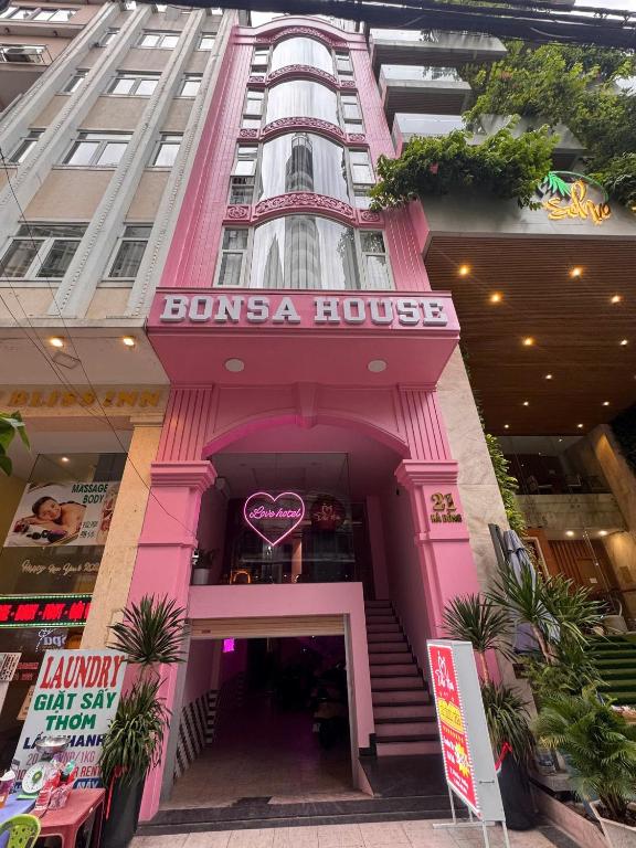 a pink building with a pink building at Đào Hoa Love Hotel Đà Nẵng in Danang