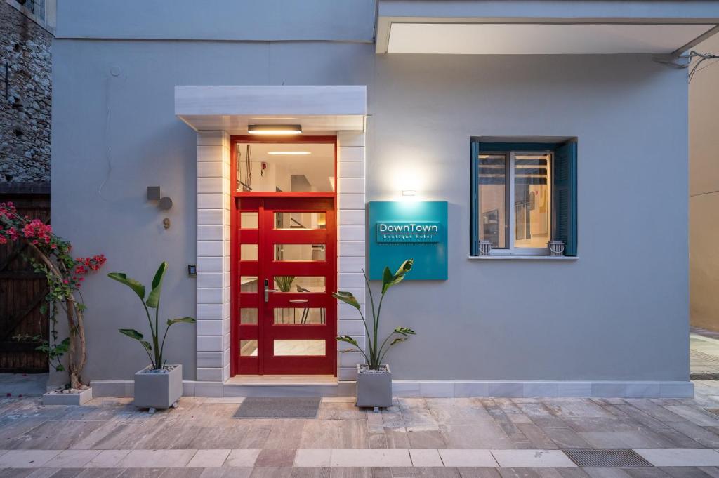 a red door on the side of a house at DownTown Hotel in Nafplio