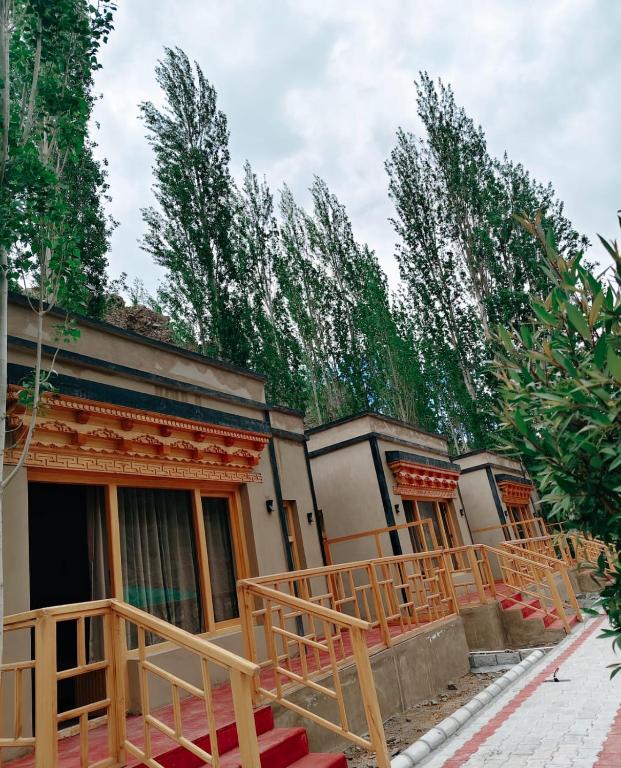 a row of houses with trees in the background at Faryok Resort in Nūrla
