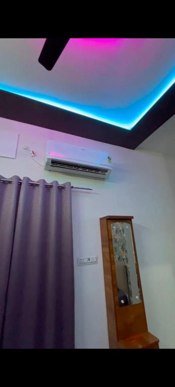 a room with a mirror and a purple ceiling at Hotel Vanilla inn in Bilāspur