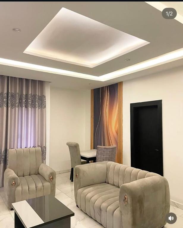 a living room with a couch and a table at Homelands in Port Harcourt