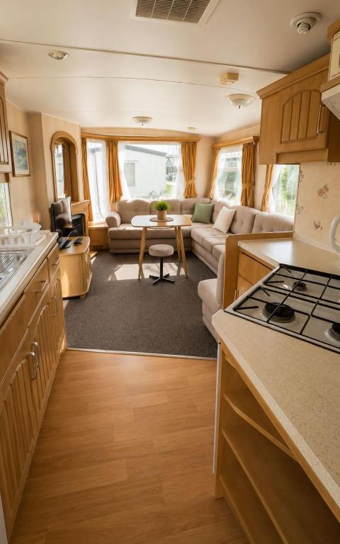 a kitchen and living room of a caravan at Rowyhills in Rowy