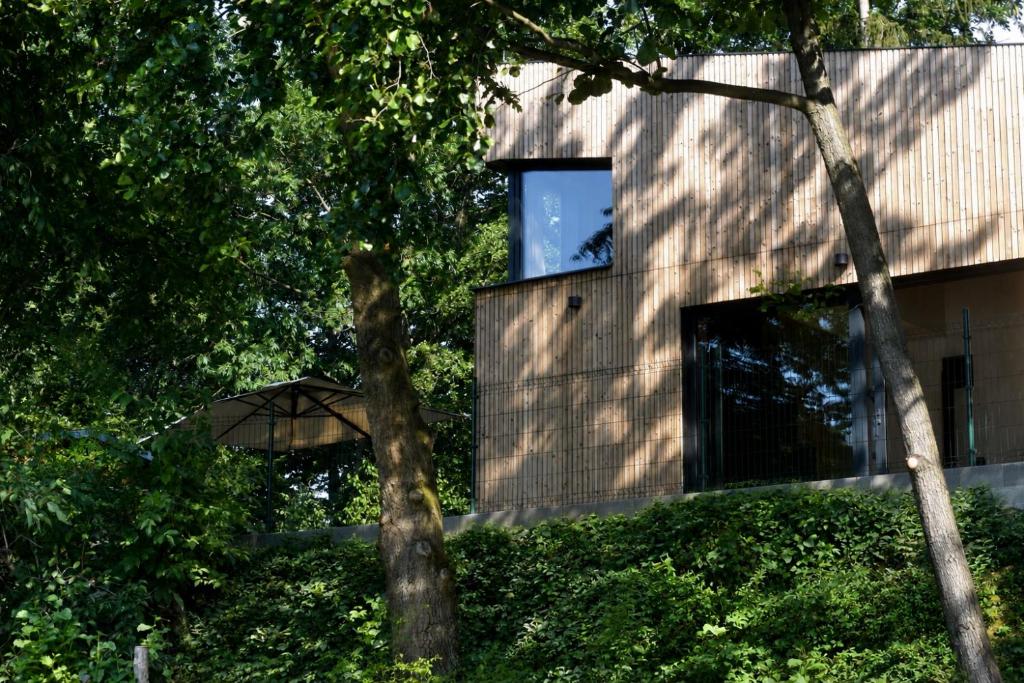a house with an umbrella in the middle of trees at Glamping Hynkov in Příkazy