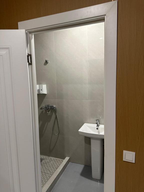 a bathroom with a shower and a sink at Отдых у речки in Almaty
