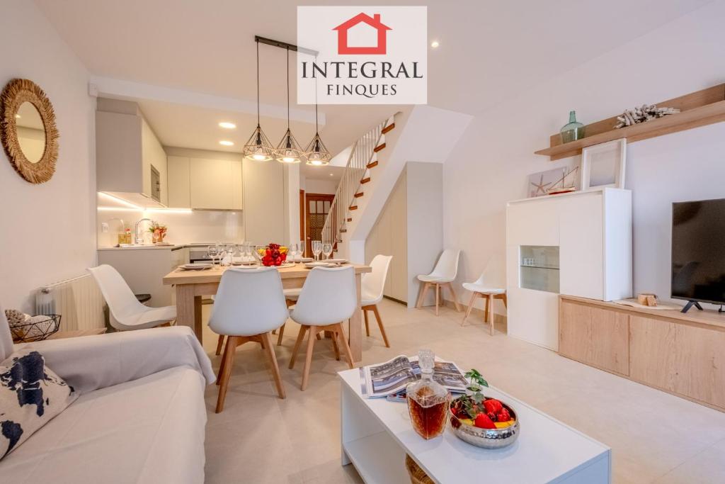 a living room with a couch and a table at Casa Norai in Palamós