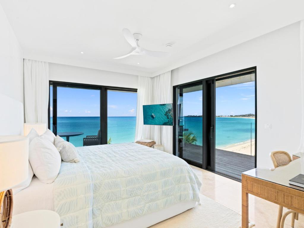 a bedroom with a bed and a view of the ocean at La Sirène in Simpson Bay