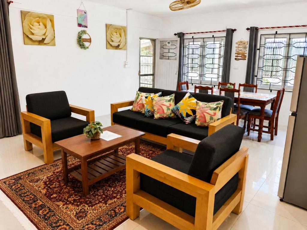 a living room with a couch and chairs and a table at The Beloved Corner in Nausori