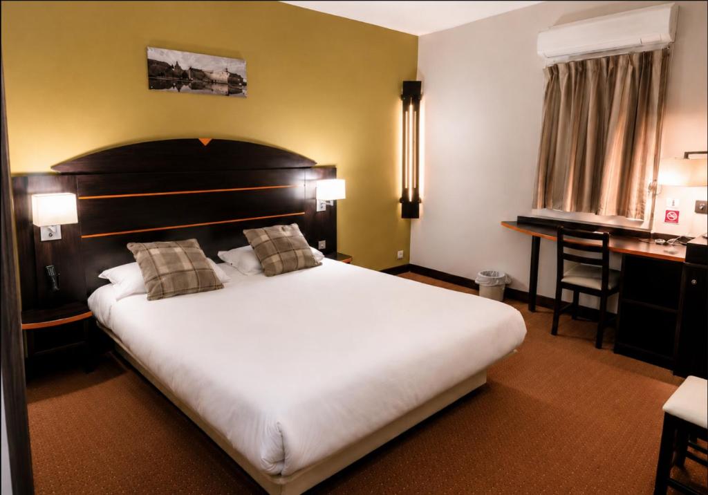 a hotel room with a large bed and a desk at Hôtel Restaurant Akena Bordeaux Sud - La Brède in La Brede