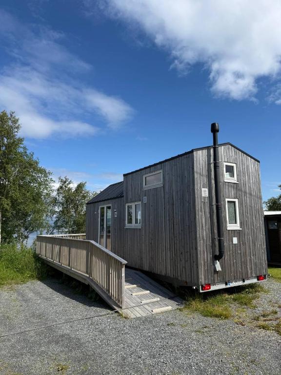 a black tiny house sitting on top of a lot at Camp Saltstraumen-Elvegård in Bodø