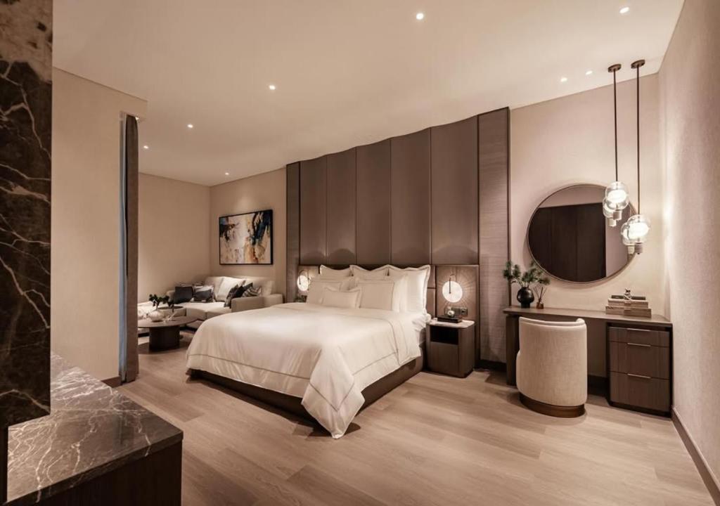 a bedroom with a large bed and a large mirror at Hotel Fairmounts Plaza Near IGI International Airport Delhi in New Delhi