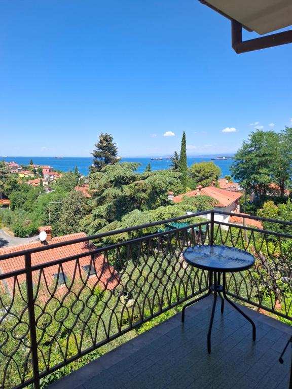 a table on a balcony with a view of the ocean at Apartma Z in Koper