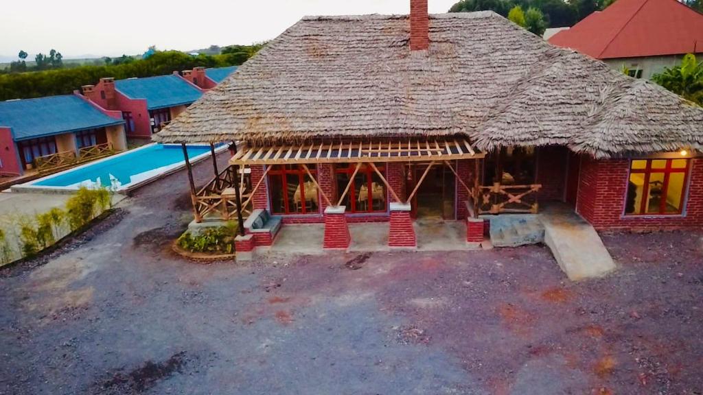 an overhead view of a house with a thatch roof at Enjipai Ngorongoro Lodge in Karatu