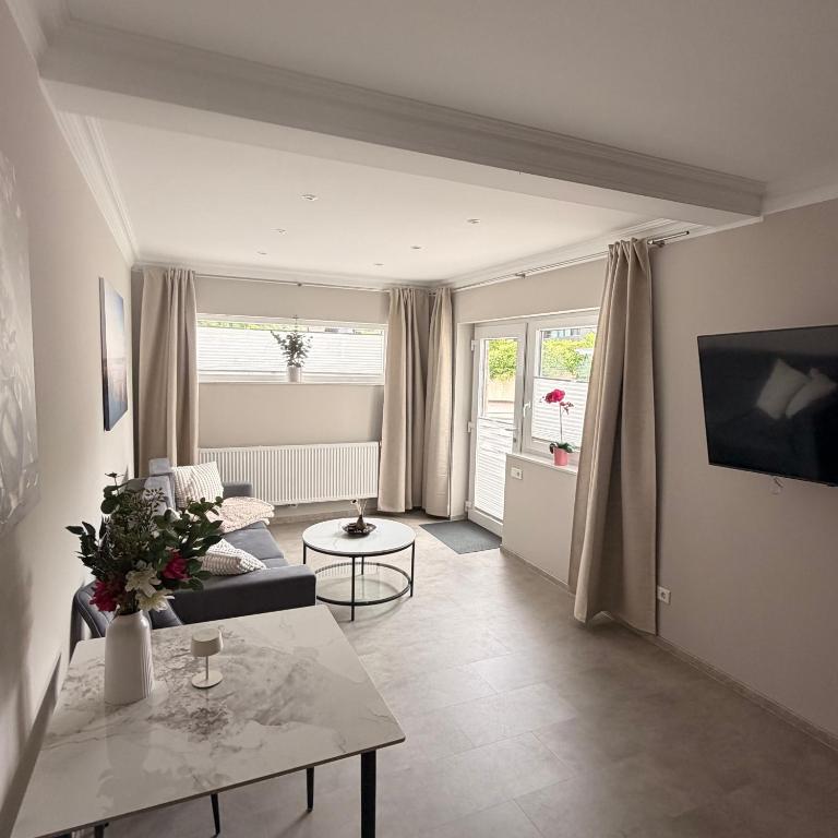 a living room with a couch and a table at Apartment MessePark Bad Salzuflen in Bad Salzuflen