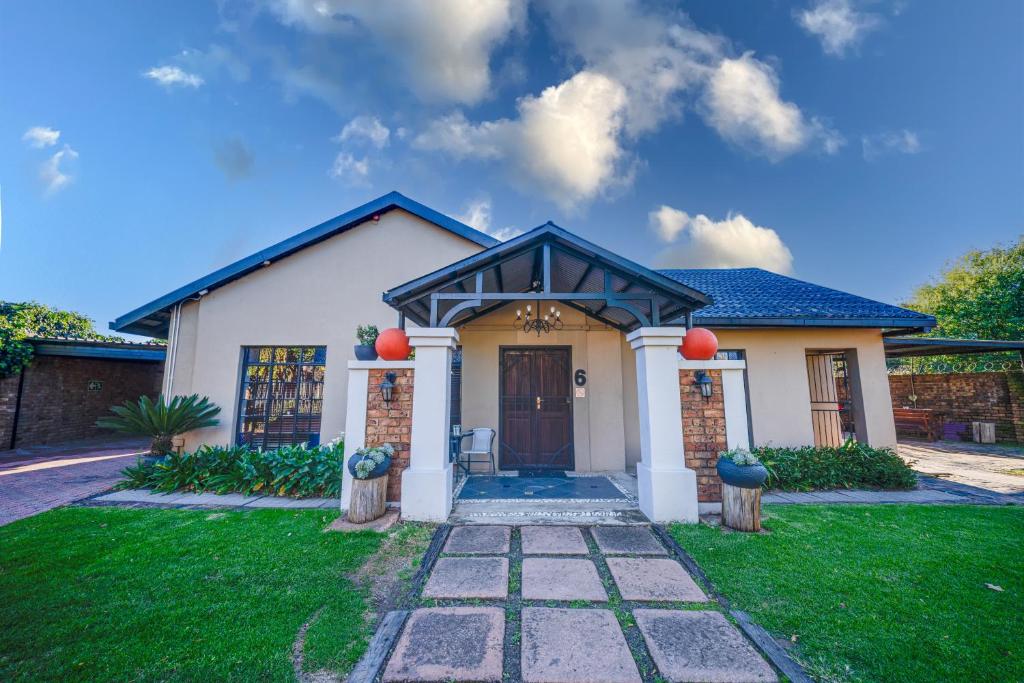 a house with a front door and a grass yard at 13 Hobson in Secunda