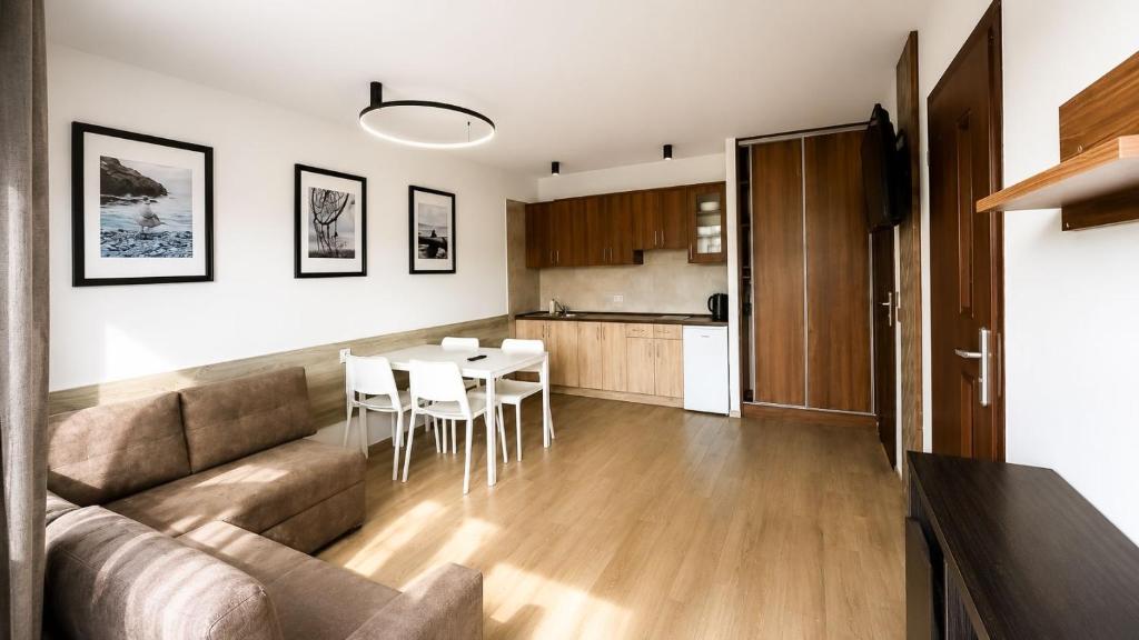 a living room and kitchen with a couch and a table at Rowyhills in Rowy