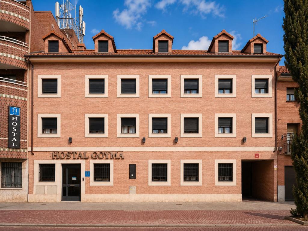 a large brick building with the words hostel guzman at Hostal Goyma III in San Fernando de Henares