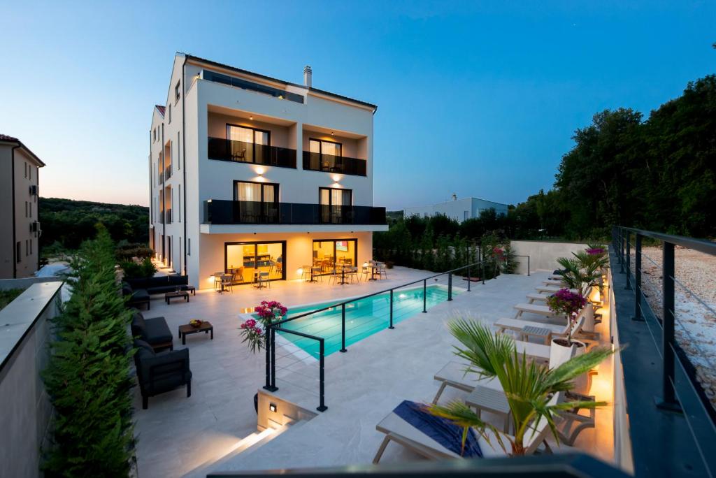 a building with a swimming pool on a balcony at Asterias Residence - New Opening 2026 in Rovinj