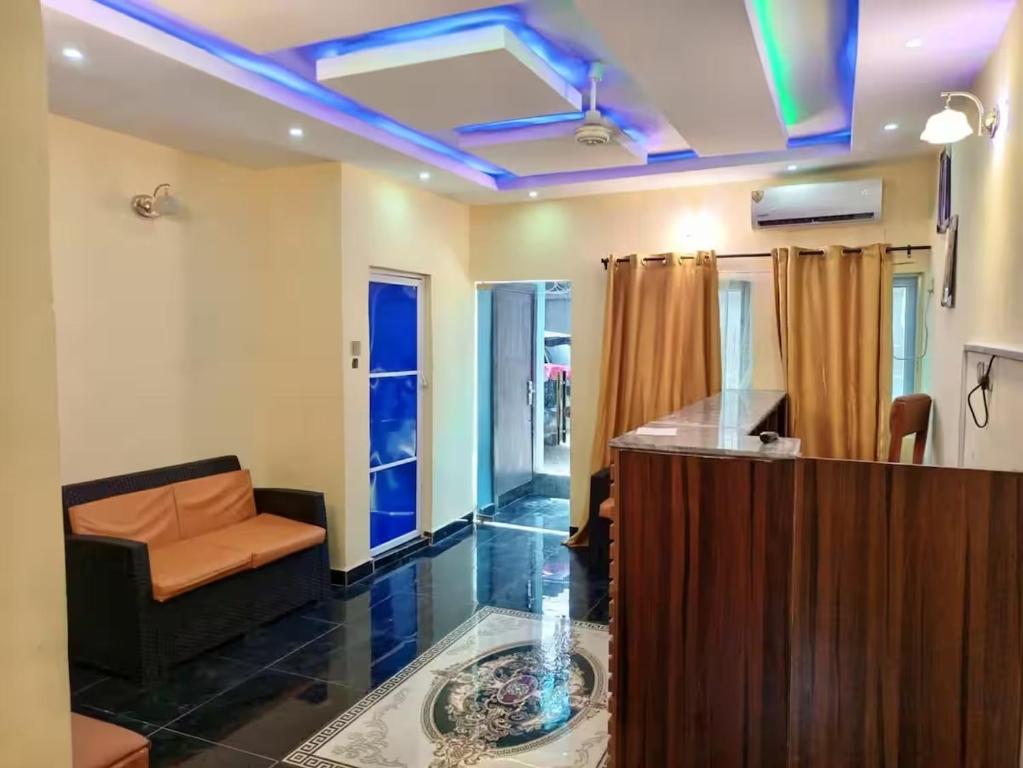 a living room with a couch and a table at Naira and Kobo Hotel in Umuahia