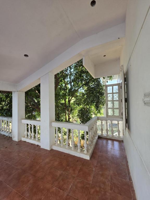 an empty room with a white railing and a balcony at AUM VILLA Homestay in Pondicherry and Auroville in Puducherry Airpoert