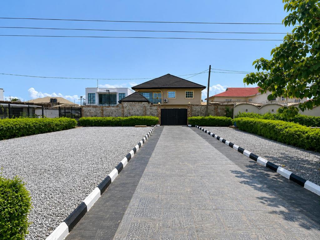 a road leading to a house with a building in the background at Kays Royal Suite in Isasi