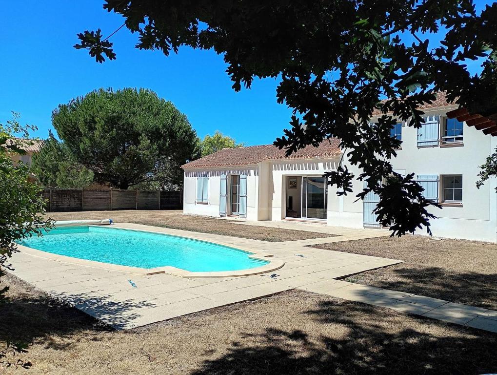a swimming pool in front of a house at Villa l Albatros - Coex in Coëx