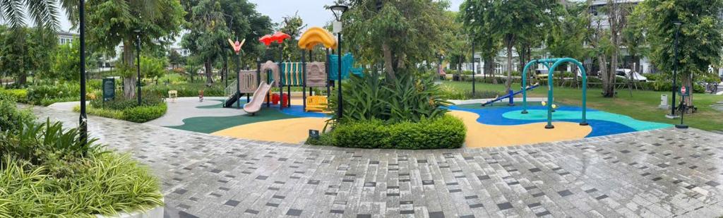 a park with a playground with a slide and swings at La Vida Residences Villa in Ấp Phước Thánh