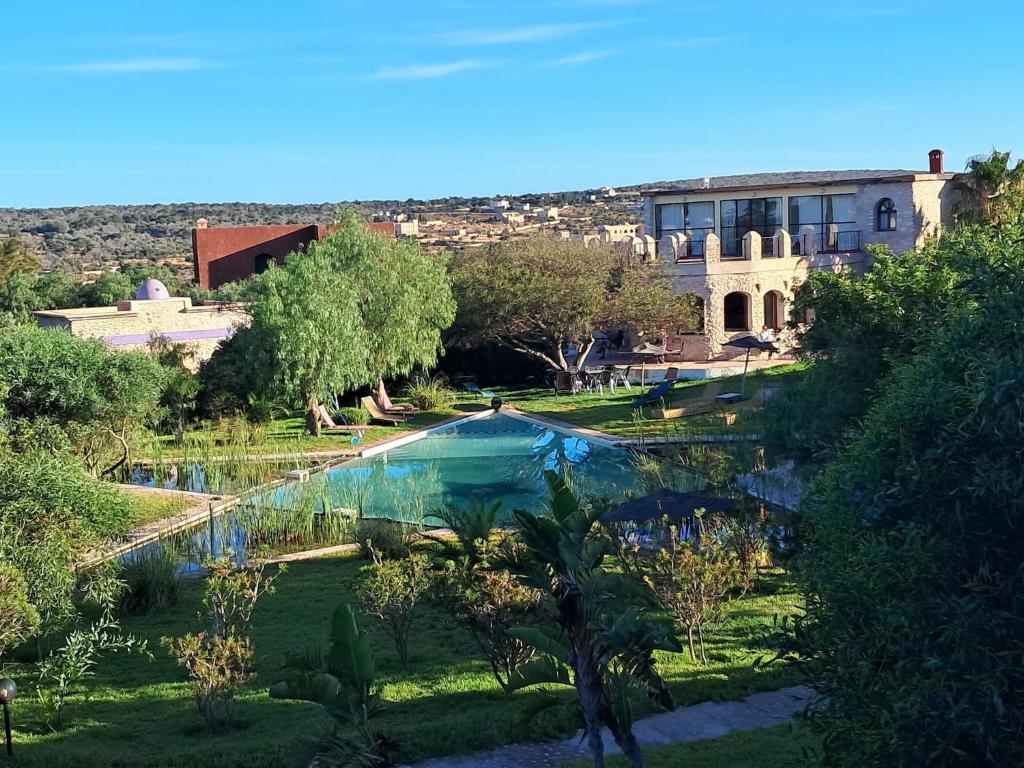 a swimming pool in a yard with a building at Douar Noujoum in Essaouira