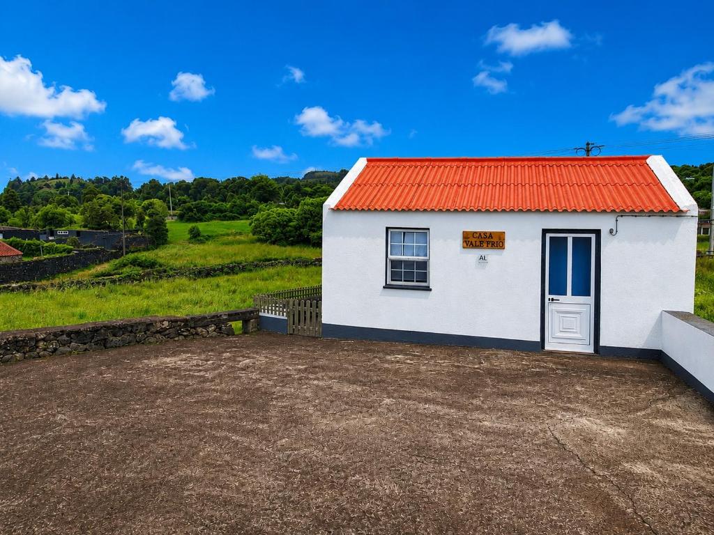 a small white building with an orange roof at Casa Vale Frio in Calheta