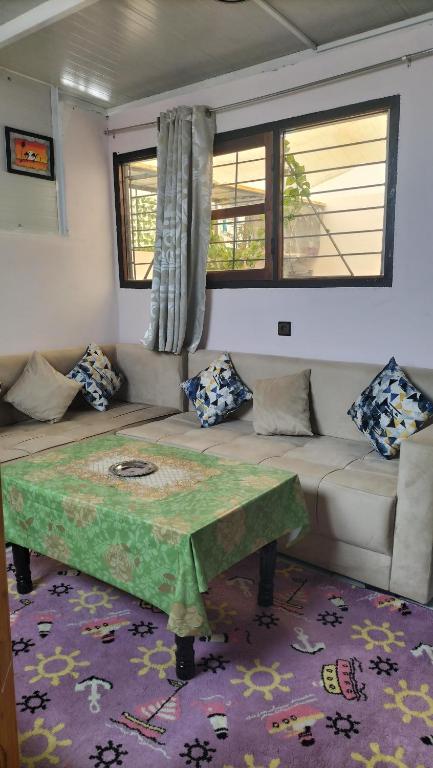 a living room with a couch and a table at Hebergement Tamazight 2 in Tarrast