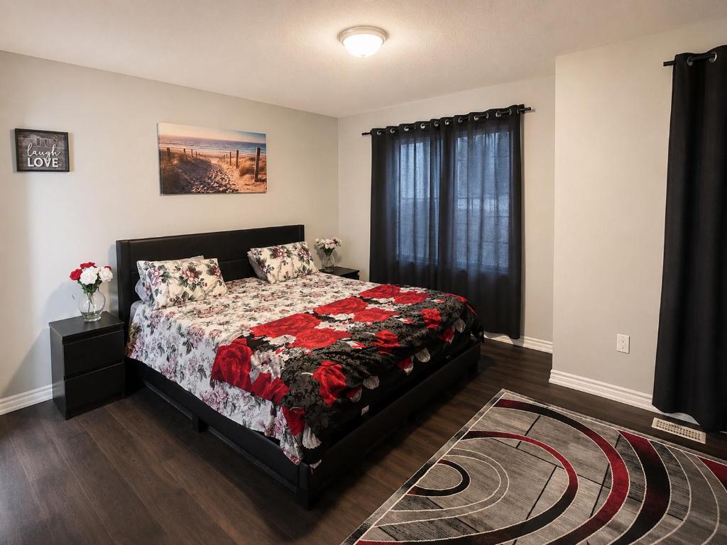 a bedroom with a bed and a window at Cozy Beautiful Home in Brampton