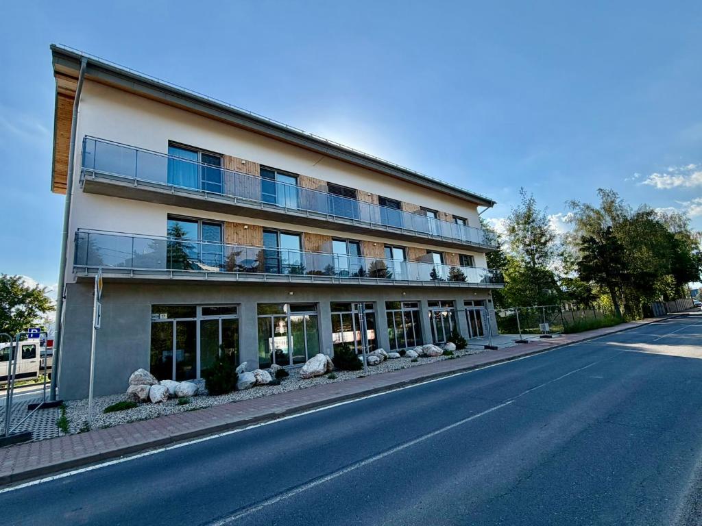 a large building on the side of a street at Ager Apartments Poprad in Poprad