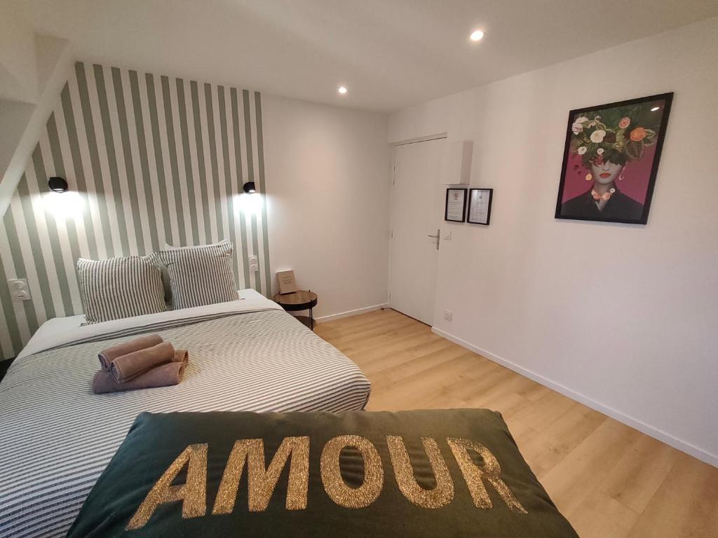 a bedroom with a bed with an amazon sign on it at Résidence du Palais in Nevers
