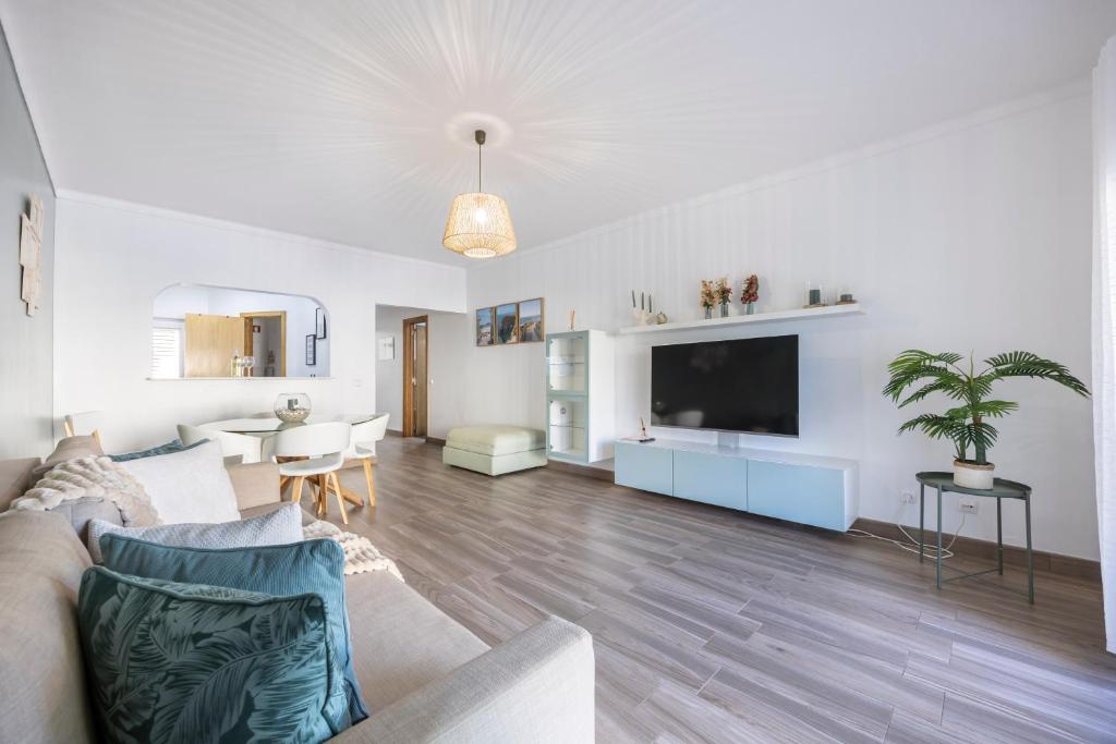 a living room with a couch and a tv at T1 Morderno - Alvor in Alvor