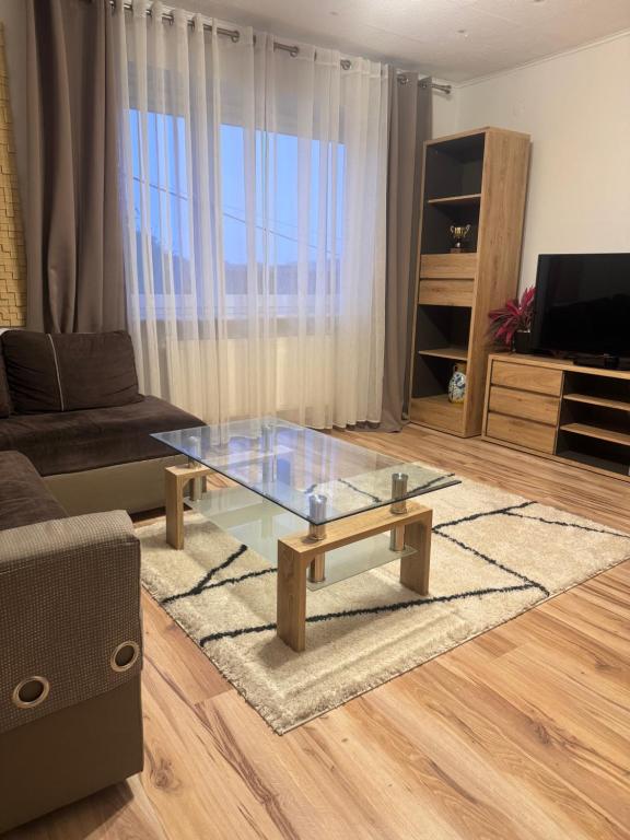 a living room with a glass table and a couch at Apartament M6 w Centrum Wiela in Wiele