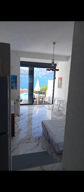 a room with a view of a living room with a bed at Mina in Krašići