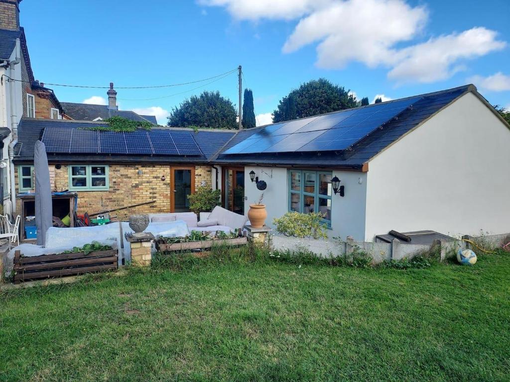 a house with solar panels on the roof at Beautiful 1-Bed Apartment in Sandy in Sandy