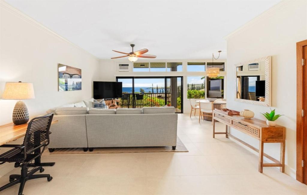 a living room with a couch and a table at 1712 Kapalua Home in Kahana