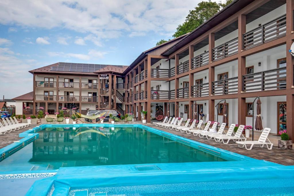 a swimming pool in front of a building with a resort at Dallas in Solotvyno