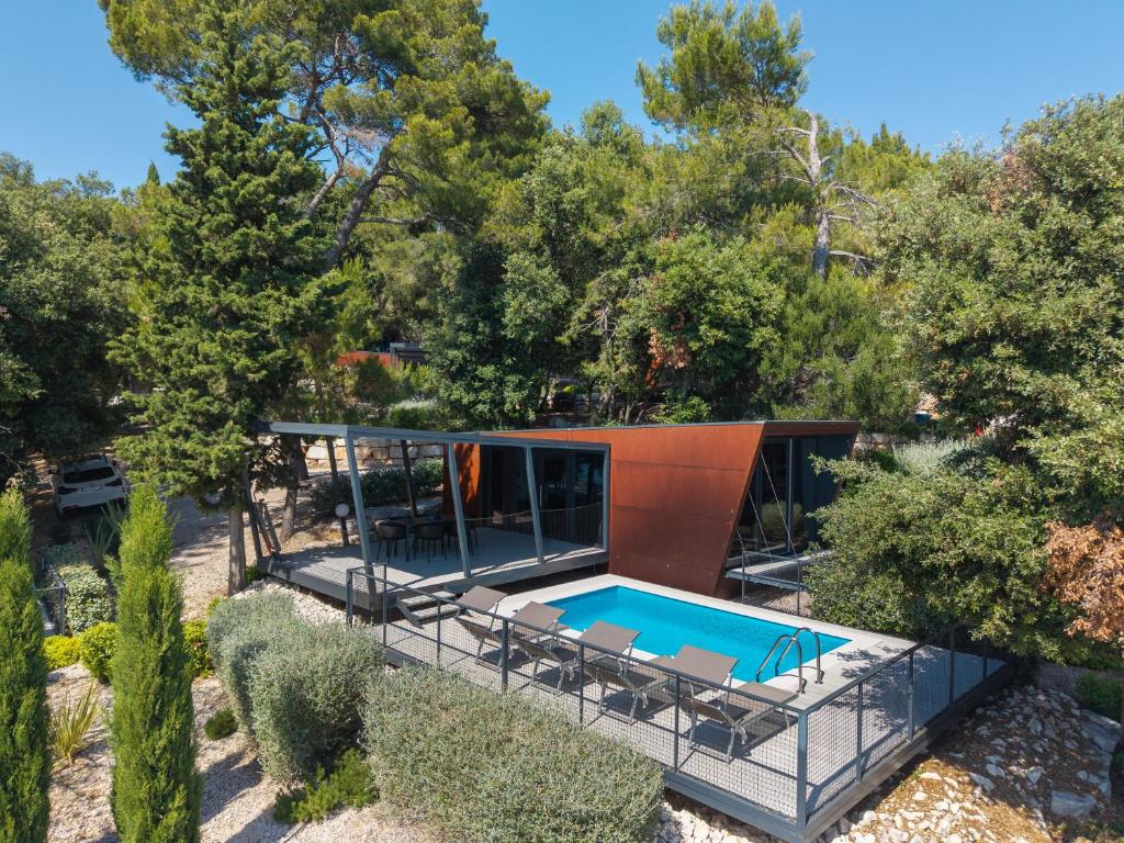 an aerial view of a house with a swimming pool at Porton Nature Hideouts in Rovinj