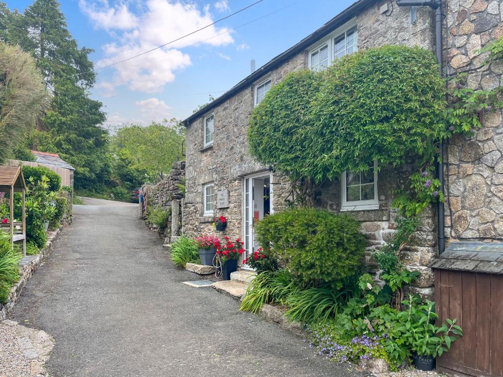 a stone house with plants on the side of it at Small Barn - Uk52140 in Liskeard